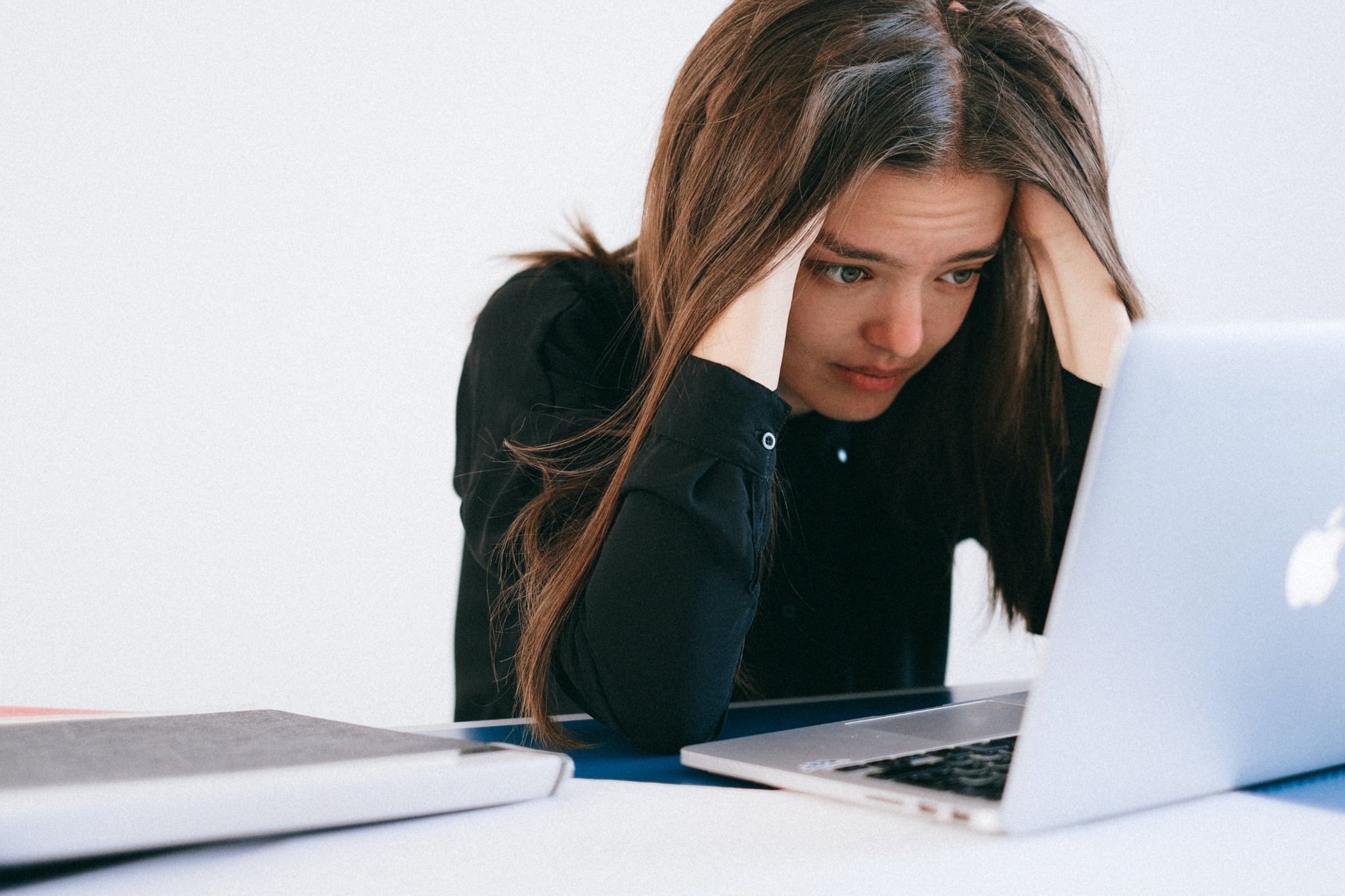woman stressed looking at laptop