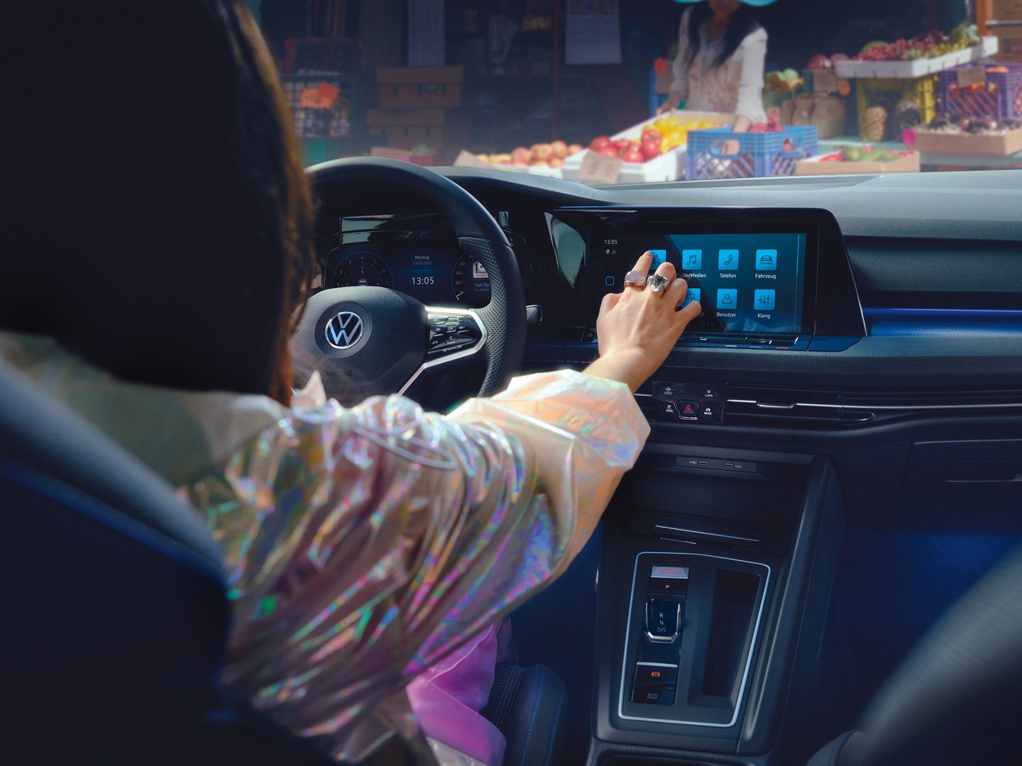 Woman using touchscreen within VW Golf GTE
